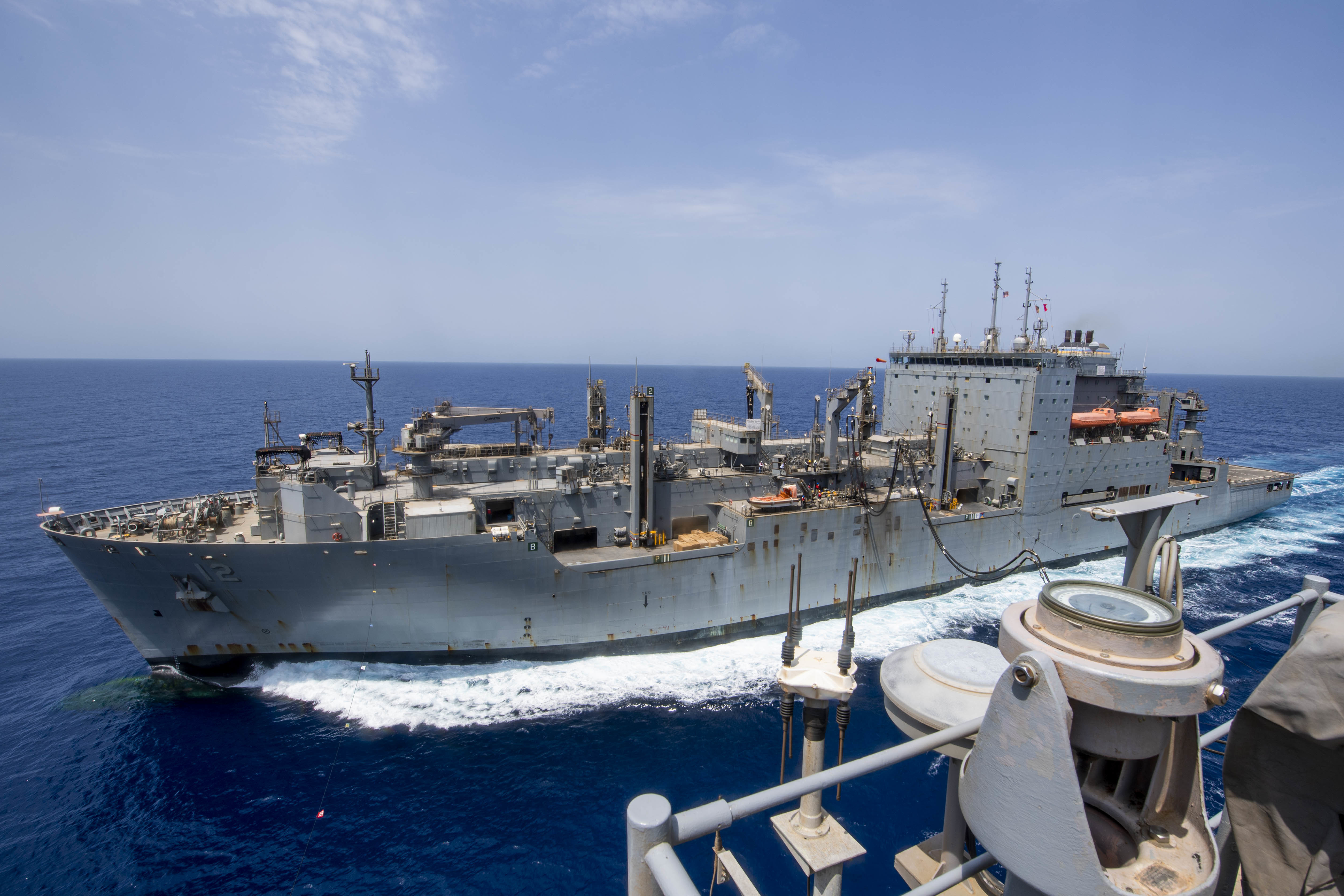 The Military Sealift Command dry cargo and ammunition ship USNS William McLean (T-AKE 12),conducts a replenishment-at-sea with the amphibious assault ship USS Iwo Jima (LHD 7) in the Gulf of Aden.