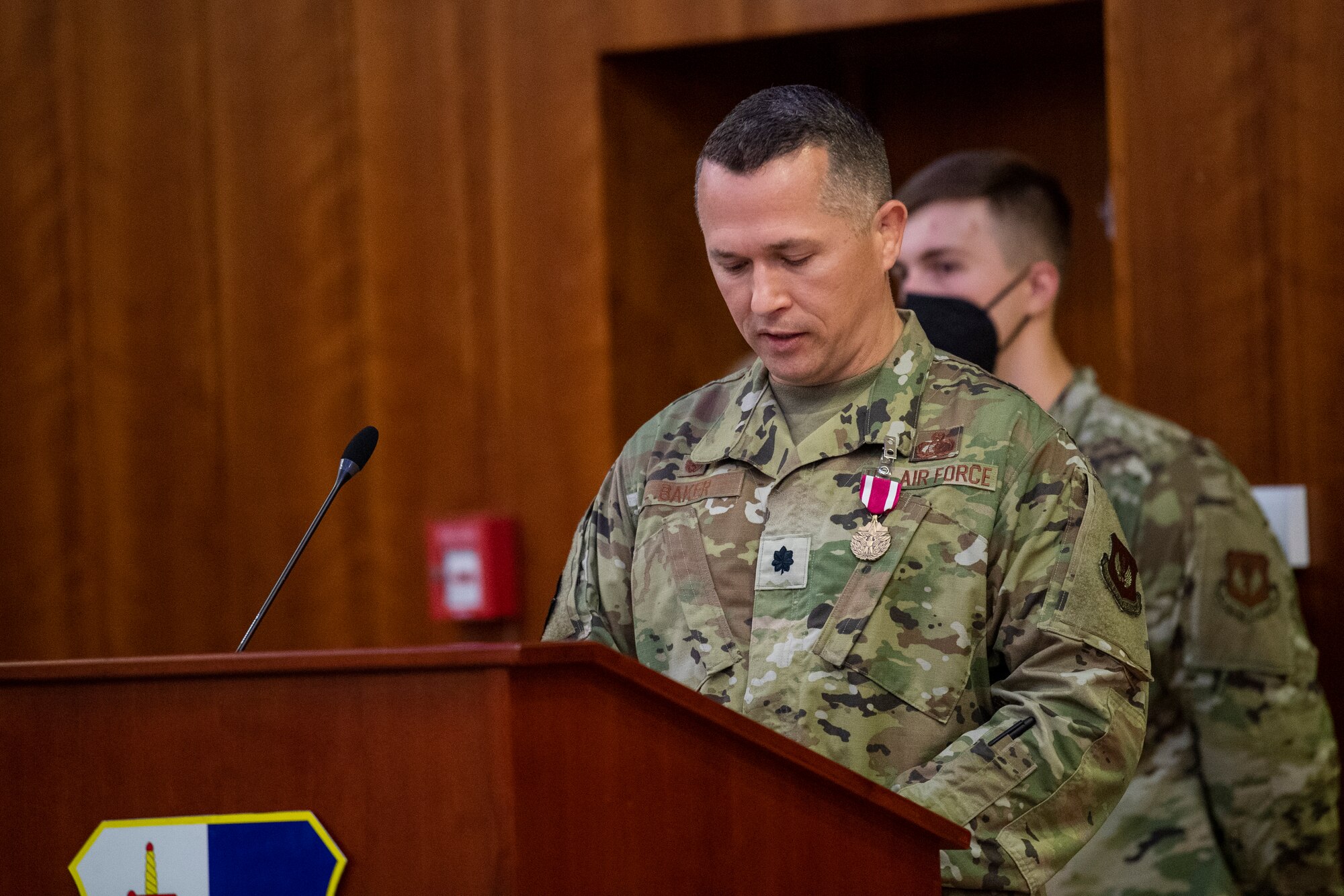 U.S. Air Force Lt. Col. Adam Baker, outgoing 52nd Force Support Squadron commander, addresses the crowd at the 52nd FSS change of command ceremony July 6, 2021, on Spangdahlem Air Base, Germany. During the ceremony, Baker relinquished command to U.S. Air Force Maj. Ingrid Muniz. (U.S. Air Force photo by Senior Airman Ali Stewart)