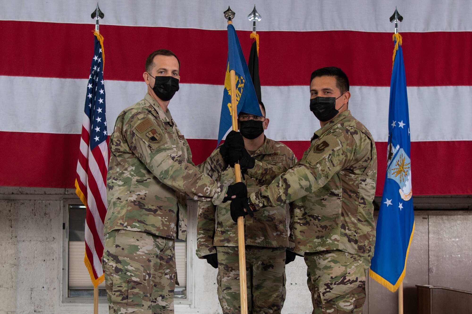 U.S. Air Force Col. James Vinson, 52nd Maintenance Group commander (left), passes the 52nd Aircraft Maintenance Squadron guidon to Maj. Bryan Beals, 52nd AMXS commander, during the squadron’s assumption of command ceremony, July 6, 2021, on Spangdahlem Air Base, Germany. The 52nd Maintenance Group provides field-level maintenance for a fleet of F-16 Fighting Falcon aircraft supporting the Supreme Allied Commander Europe with expeditionary airpower, specializing in suppression of enemy air defenses, air interdiction, strategic attack, close air support, and combat search and rescue missions. (U.S. Air Force photo by Staff Sgt. Melody W. Howley)