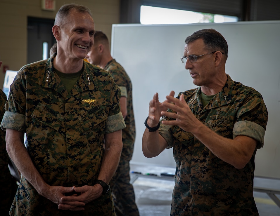U.S. Marine Corps Gen. Gary L. Thomas, left, the assistant commandant of the Marine Corps, talks with Maj. Gen. Francis L. Donovan, the commanding general of 2d Marine Division (MARDIV) , at Camp Lejeune, N.C., July 7, 2021. Thomas visited 2d MARDIV to observe how the division plans to adapt in accordance with Force Design 2030, which looks to increase the lethality and littoral combat ability of the Marine Corps. (U.S. Marine Corps photo by Lance Cpl. Brian Bolin Jr.)