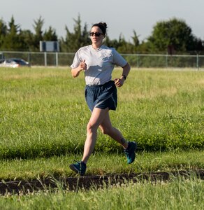 Tech. Sgt. Katie Maricle, Air Force Mortuary Affairs Operations Unit Fitness Program Monitor, completes a run at Dover Air Force Base, Delaware, June 23, 2021. Maricle runs three times a week and is currently training for her fourth half marathon in October. (U.S. Air Force photo by Jason Minto)