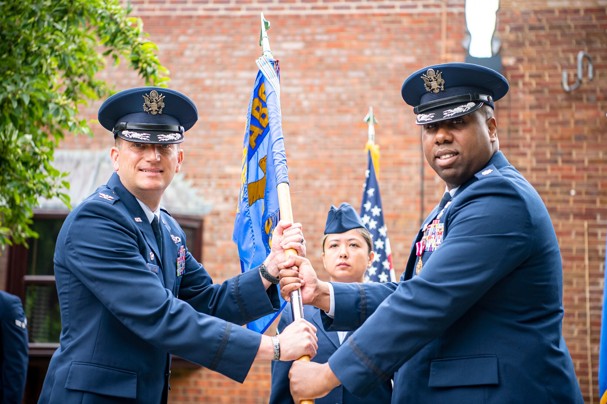 U.S. Air Force Col. Richard Martin, left, 423rd Air Base Group commander, receives the 423rd Force Support Squadron guidon from Lt. Col. Jarvora Duncan, 423rd Force Support Squadron outgoing commander, during a change of command ceremony at RAF Alconbury, England, July 8, 2021. The ceremony is a military tradition that represents a formal transfer of a unit’s authority and responsibility from one commander to another. (U.S. Air Force photo by Senior Airman Eugene Oliver)