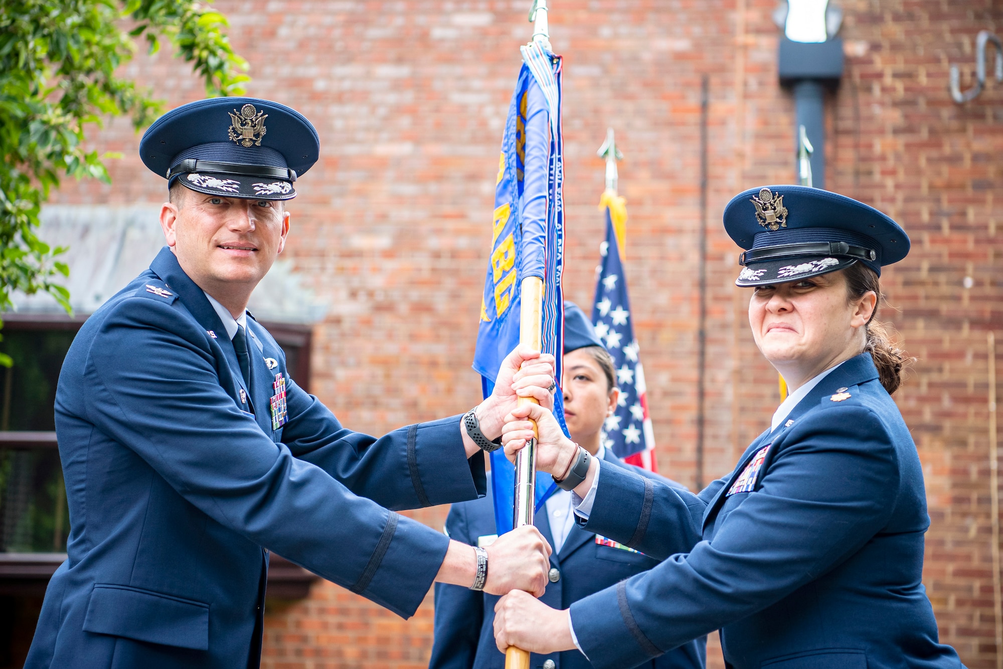 U.S. Air Force Col. Richard Martin, left, 423rd Air Base Group commander, presents the 423rd Force Support Squadron guidon to Maj. Kirsten Nicholls, 423rd Force Support Squadron incoming commander, during a change of command ceremony at RAF Alconbury, England, July 8, 2021. Prior to assuming command of the 423rd FSS Nicholls was a student at the Air Command and Staff College, Maxwell AFB, Alabama. (U.S. Air Force photo by Senior Airman Eugene Oliver)