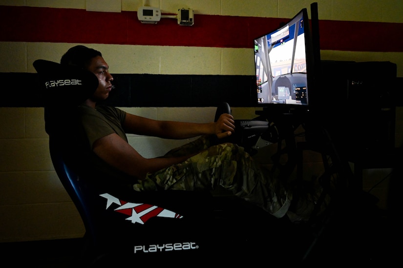 U.S. Army Pvt. Dominico Brown, Advanced Individual Training student, drives a racing simulator at Joint Base Langley-Eustis, Virginia. June 28, 2021. The simulator is part of the Fort Eustis USO’s inventory of entertainment that’s free for all U.S. service members. (U.S. Air Force photo by Senior Airman John Foister)