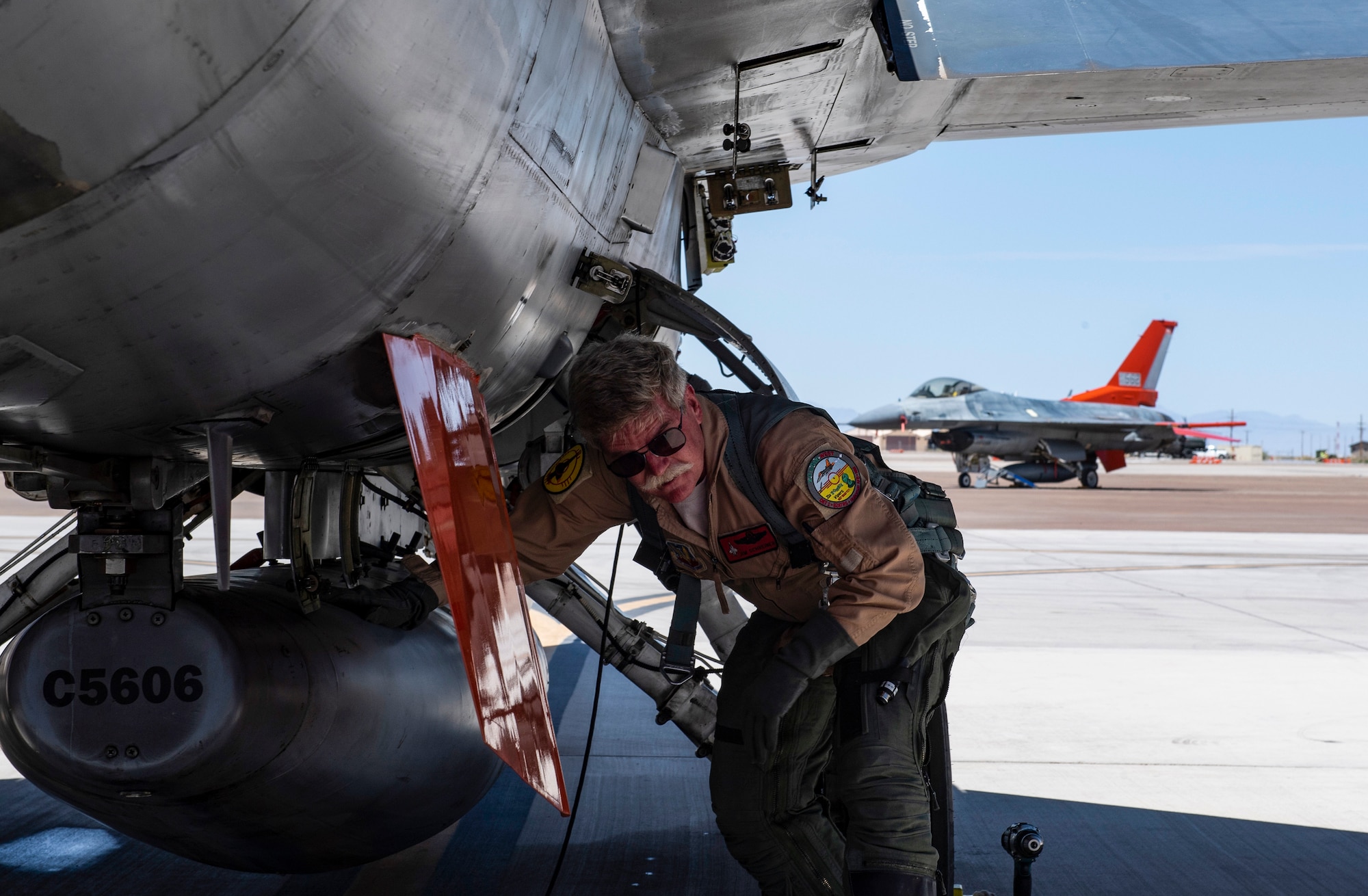 Jim Schreiner, Civilian QF-16 pilot/controller, preflights a QF-16 before a manned dress rehearsal of a missile test on a QF-16 at Holloman Air Force Base, New Mexico. (U.S. Air Force photo by Tech. Sgt. Perry Aston)