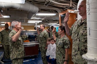 SAN DIEGO (June 4, 2021) Vice Adm. Roy Kitchener, Commander, Naval Surface Force, U.S. Pacific Fleet, conducts a reenlistment on the mess decks aboard the Arleigh Burke-class guided-missile destroyer USS Howard (DDG 83).  While visiting the ship, Kitchener evaluated Howard’s current state of readiness and spoke with Sailors. (U.S. Navy photo by Mass Communication Specialist 2nd Class Kevin C. Leitner)