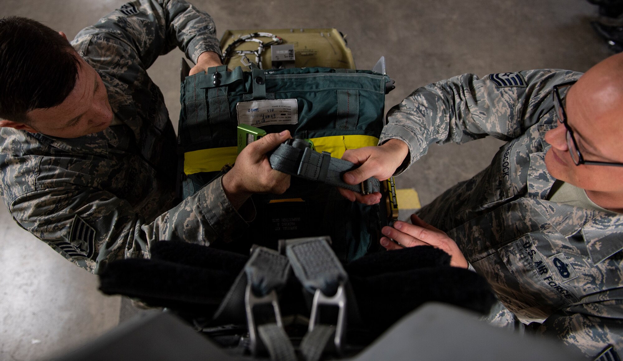 Egress Craftsman, from the 846th Test Squadron, assemble an Advanced Concept Ejection Seat II, at the Holloman High Speed Test Track, At Holloman Air Force Base, NM. New hemet designs or flight gear are required to be tested before being fielded, to ensure the aircrew will be safe when ejecting from an aircraft. (U.S. Air Force photo by Tech. Sgt. Perry Aston)