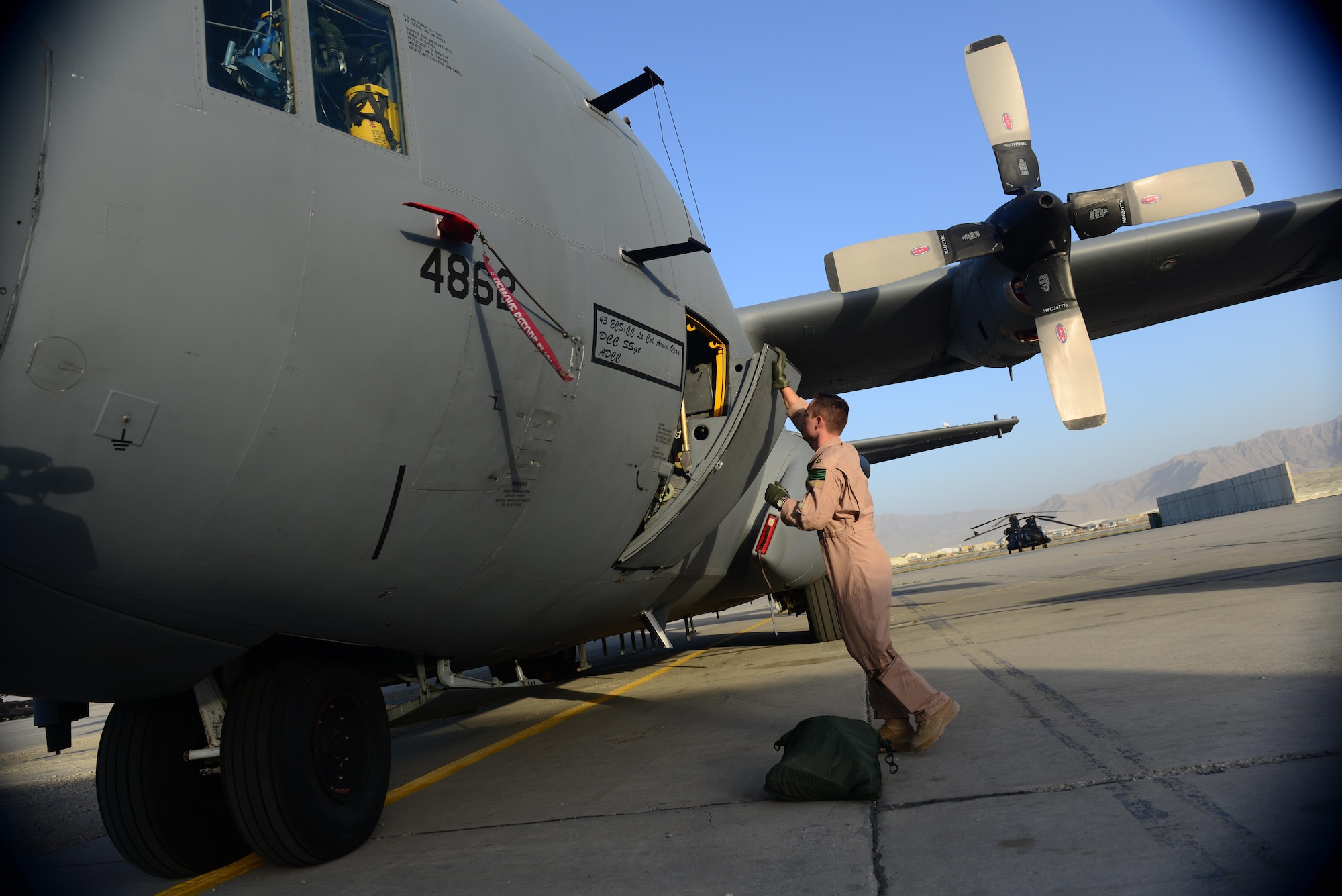 U.S. Air Force Capt. Frank Von Heiland, 41st Expeditionary Electronic Combat Squadron co-pilot, opens a crew door of an EC-130H Compass Call aircraft at Bagram Airfield, Afghanistan Sept. 12, 2014.  The 41 EECS provides premier counter-communications electronic attack capabilities. Von Heiland is deployed from Davis-Monthan Air Force Base, Ariz. and a native of Anaheim, Calif. (U.S. Air Force photo by Staff Sgt. Evelyn Chavez/Released)