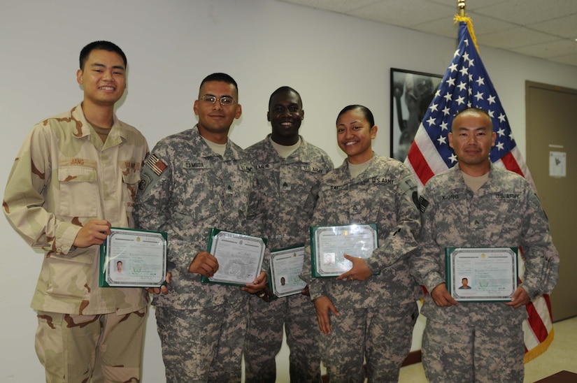Five service members display certificates.