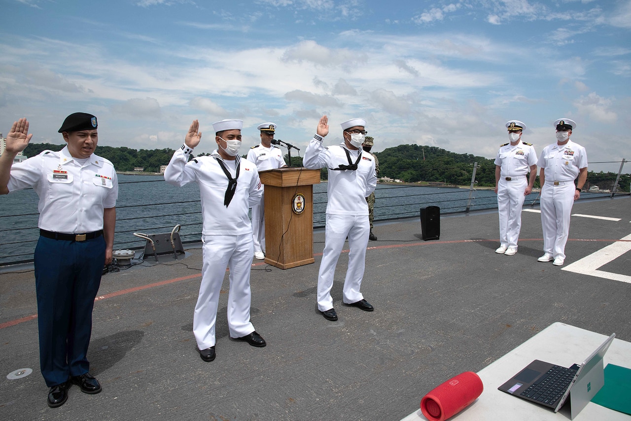 Sailors participate in a naturalization ceremony.