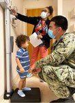 Photo By Deidre Smith | JACKSONVILLE, Fla. (June 17, 2021) – Aviation Maintenance Administrationman 2nd Class Justin West places his 2-year-old son on a scale to be weighed by a medical assistant at Naval Hospital Jacksonville’s Pediatrics Clinic. West says, “Knowing that my son receives quality care allows me to focus on doing my job and meeting the mission.” (U.S. Navy photo by Deidre Smith, Naval Hospital Jacksonville/Released).