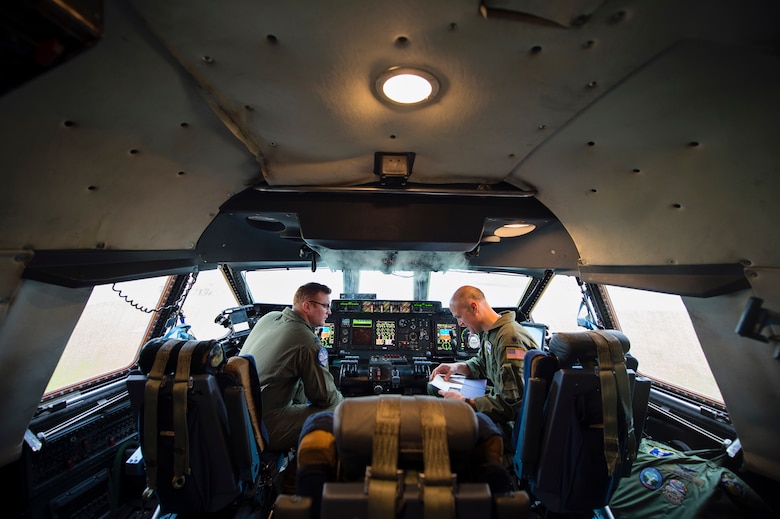 Capt. Grant Bearden (left) and Lt. Col. Timothy Welter, both pilots with the 709th Airlift Squadron, go over their pre-flight checklist in the C-5M Super Galaxy March 28, 2016, at Naval Air Station Pensacola, Fla. Reservists from Dover Air Force Base, Del., in the 512th Airlift Wing, conducted an off-station training event to satisfy most deployment requirements in one large exercise. (U.S. Air Force photo/Capt. Bernie Kale)