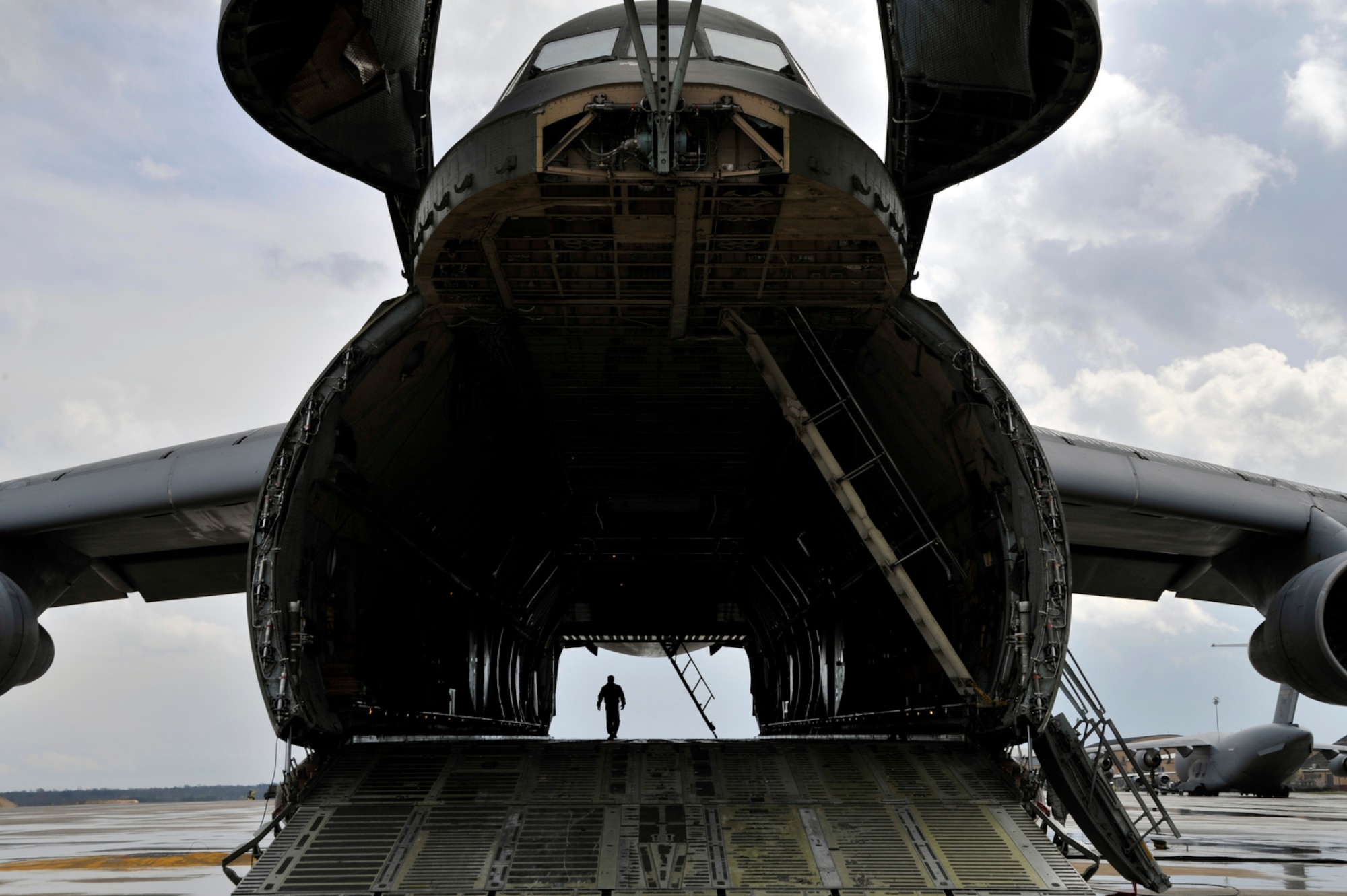 Airmen prepare a C-5 Galaxy for cargo, April 2, at Joint Base Andrews, Md. Ground crews are able to load and off-load the C-5 simultaneously at the front and rear cargo openings, reducing cargo transfer times. (U.S. Air Force photo/Senior Airman Perry Aston)