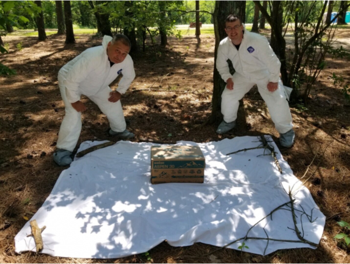 Kentucky Army National Guard Col. Jesse Huff, the outgoing preventive medicine officer for the Kentucky Medical Detachment, and Capt. Bryan Parker, the incoming preventive medicine officer, use a cardboard box with dry ice to bait ticks for collection at Wendell H. Ford Regional Training Center, Greenville, Kentucky, June 1, 2021. Huff has been collecting ticks to aid in prevention of tick-borne illnesses for more than 20 years. (photo by U.S. Army National Guard Sgt. Lance Mudd)