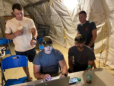 Left to right: Staff Sgts. William Wilkins, Nathaniel Fort, Kevin Sarsick and Nicholas Maniacek, deployed firefighters from the Wisconsin Air National Guard’s 115th Fighter Wing, take part in online training for incident command system certification this year from their base in Africa. The training was a collaborative effort with Wisconsin Emergency Management and the REACT Center at Volk Field.