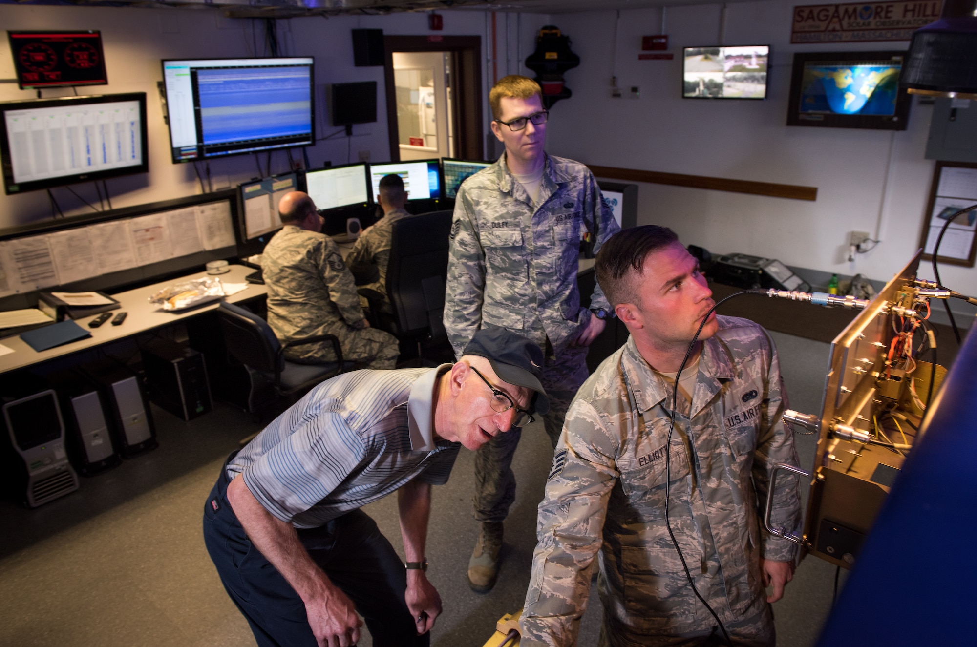 Retired U.S. Air Force Master Sgt. Daniel Holmes, center, tests radio equipment with Staff Sgt. Jake Elliot Radio Interference Telescope technician, right, and Tech. Sgt. Kyle Duley, maintenance NCIOC at the Sagamore Hill Solar Observatory of the 2nd Weather Squadron, Det. 2, in Hamilton, Mass., Jun. 1, 2018. The 2nd WS, headquartered at Offutt Air Force Base, Neb., operates four solar observatories around the globe which enable constant monitoring of the sun for solar phenomenon which may interfere with electronics and communications used by the Department of Defense. (U.S. Air Force photo by J.M. Eddins Jr.)
