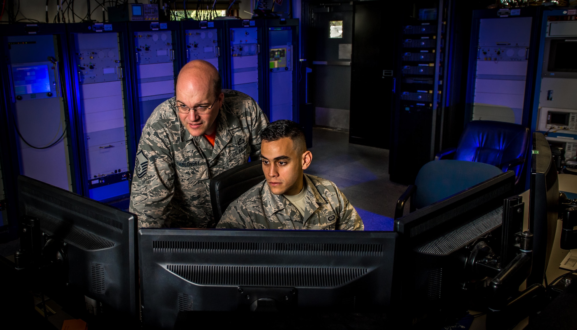 Master Sgt. Timothy Yablonsky, left, a space weather forecaster and detachment chief, and Senior Airman Zachary Lopez monitor radio signals emanating from the sun at the Sagamore Hill Solar Observatory of the 2nd Weather Squadron, Det. 2, in Hamilton, Mass., Jun. 1, 2018. The 2nd WS, headquartered at Offutt Air Force Base, Neb., operates four solar observatories around the globe which enable constant monitoring of the sun for solar phenomenon which may interfere with electronics and communications used by the Department of Defense. (U.S. Air Force photo by J.M. Eddins Jr.)