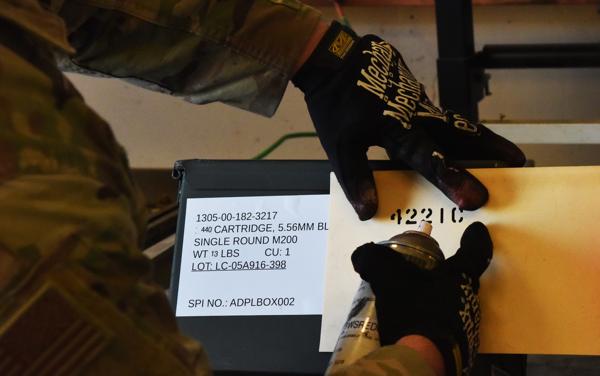 An Ammo Airman from the 341st Munitions Squadron marks an ammo can with the appropriate unit designation before issuing July 6, 2021, at Malmstrom Air Force Base, Mont. Munitions Airmen store, maintain, inventory and issue explosive materials for use by other units on the base. (U.S. Air Force photo by Tech. Sgt. Joseph Park)
