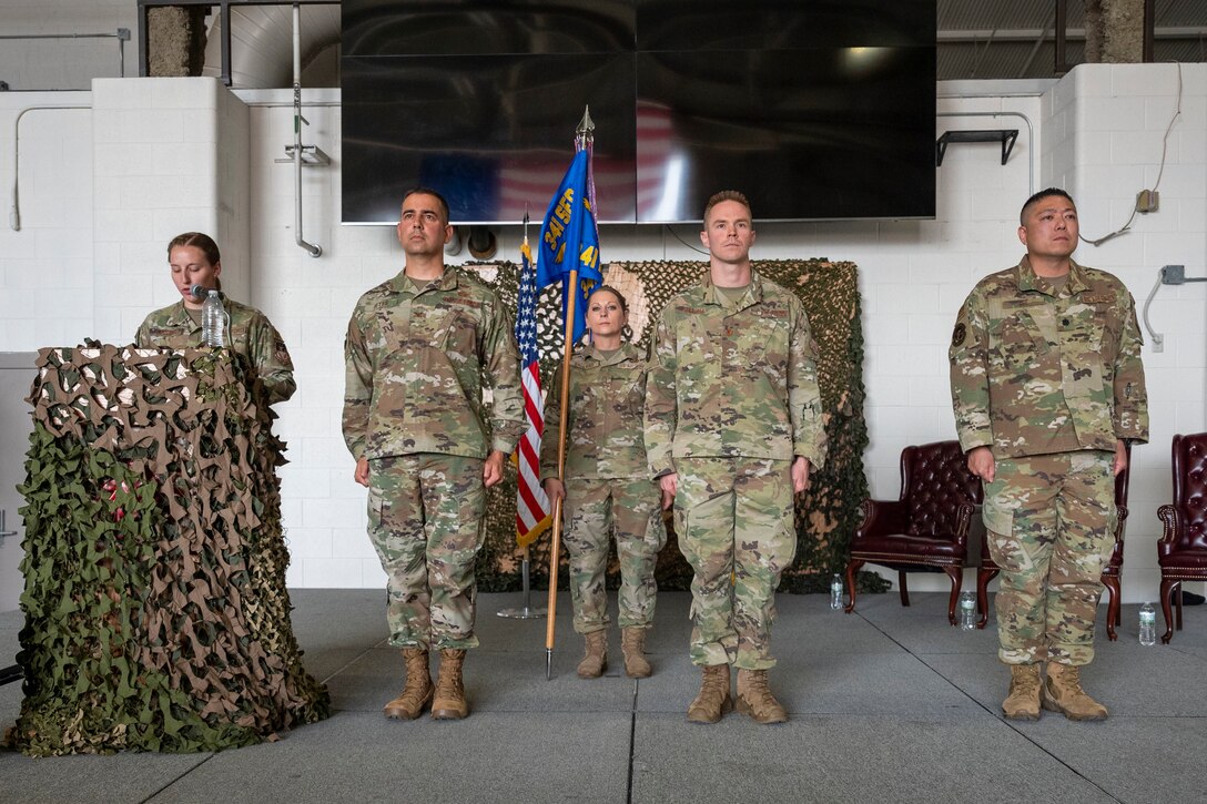 From left, Col. Frank Reyes, 341st Security Forces Group commander; Maj. Brian Gilliam, 341st MSOS outgoing commander; and Lt. Col. Min Lee, 341st MSOS incoming commander, stand at attention while 1st Lt. Leslie Fallert, 341st MSOS logistics and resources officer and ceremony emcee, reads the orders during a change of command ceremony July 7, 2021, at Malmstrom Air Force Base, Mont.