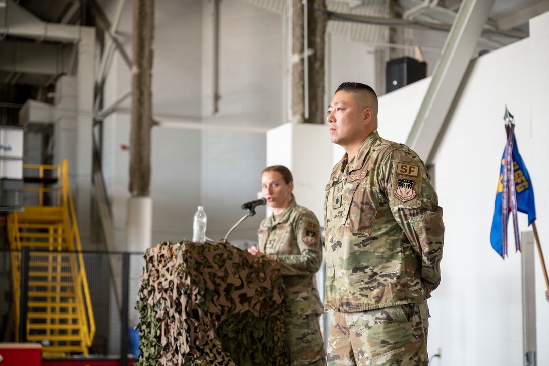 Lt. Col. Min Lee, 341st Missile Security Operations Squadron incoming commander, looks on as 1st Lt. Leslie Fallert, 341st MSOS logistics and resources officer and ceremony emcee, introduces Lee to his new squadron during a change of command ceremony July 7, 2021, at Malmstrom Air Force Base, Mont.
