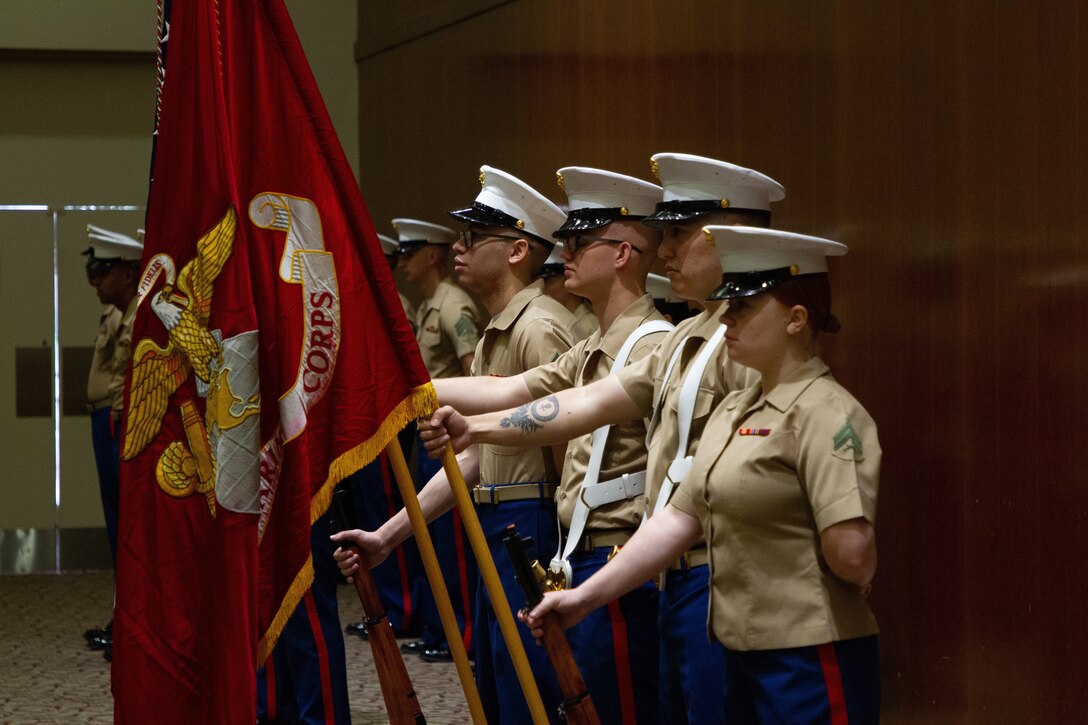 The Recruiting Station Raleigh color guard stands at parade rest during the Recruiting Station Raleigh Change of Command Ceremony held at the McKimmon Center in Raleigh, North Carolina, June 28, 2021. The outgoing Commanding Officer Maj. Dennis Dunbar relinquished command to Maj. Chad Kelling.