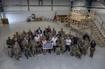 A group photo of military and civilian members during the USO Tour at Joint Base San Antonio.