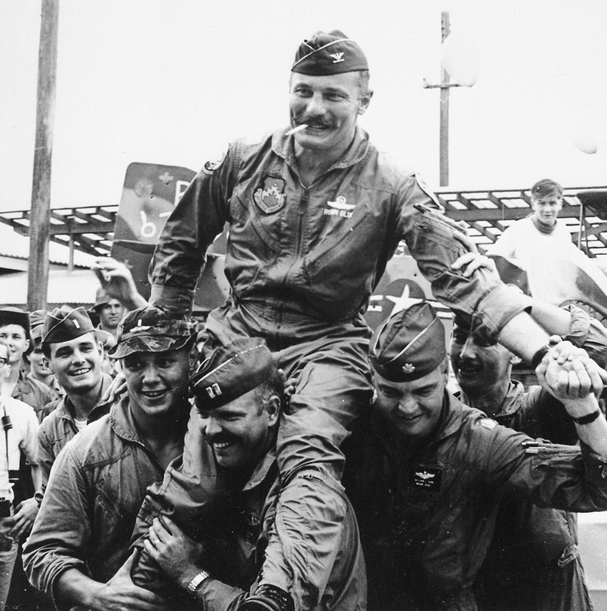 "Wolfpack" aviators of the 8th Tactical Fighter Wing carry their Commanding Officer, Colonel Robin Olds, following his return from his last combat mission over North Vietnam, on 23 September 1967. This mission was his hundredth "official" combat mission, but his actual combat mission total for his tour was 152. Olds led the 8th TFW Wolfpack from September 1966 through September 1967, as it amassed 24 MiG victories, the greatest aerial combat record of an F-4 Wing in the Vietnam war. (U.S. Air Force photo)