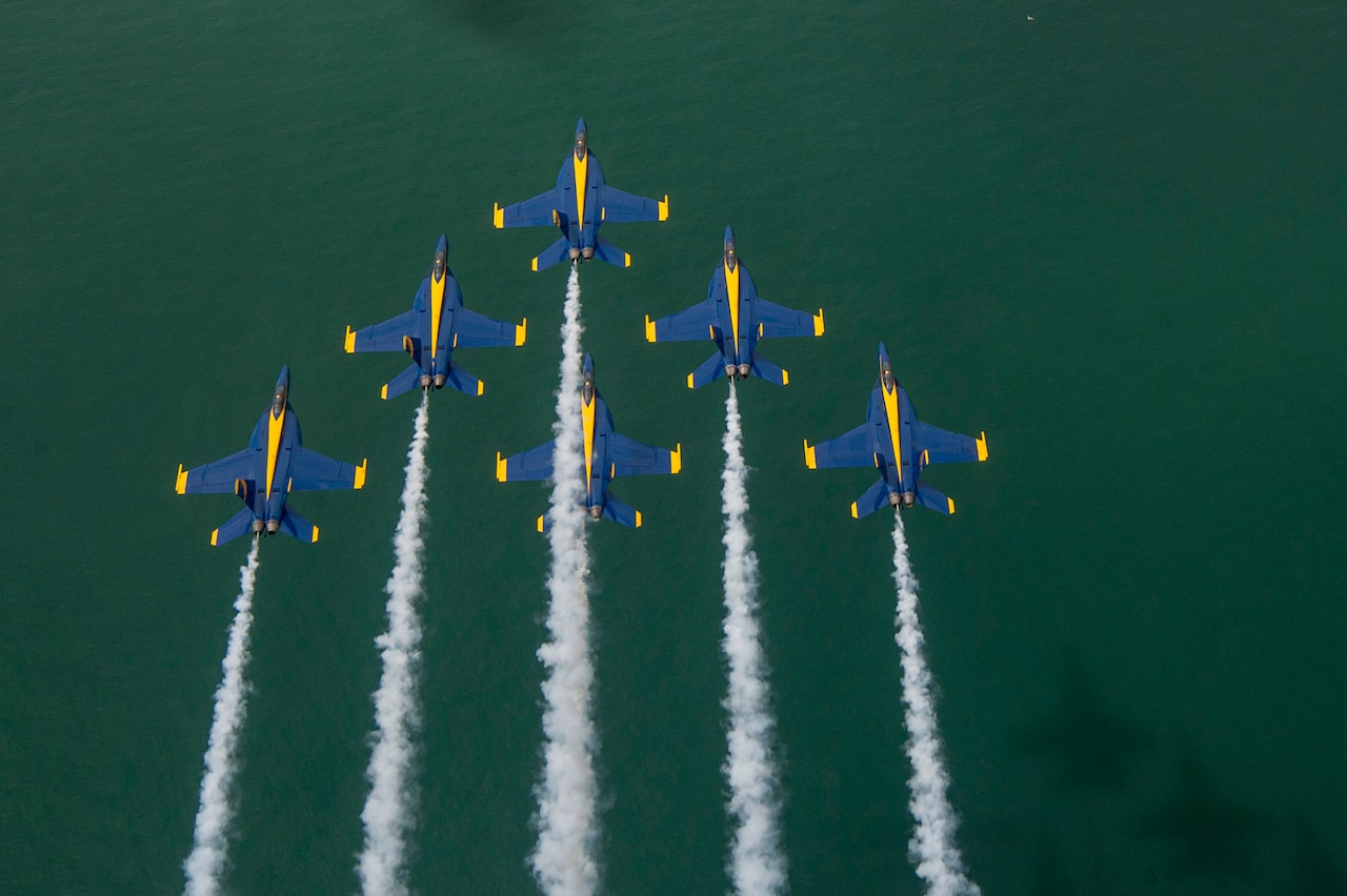 Aircraft fly information over a body of water.