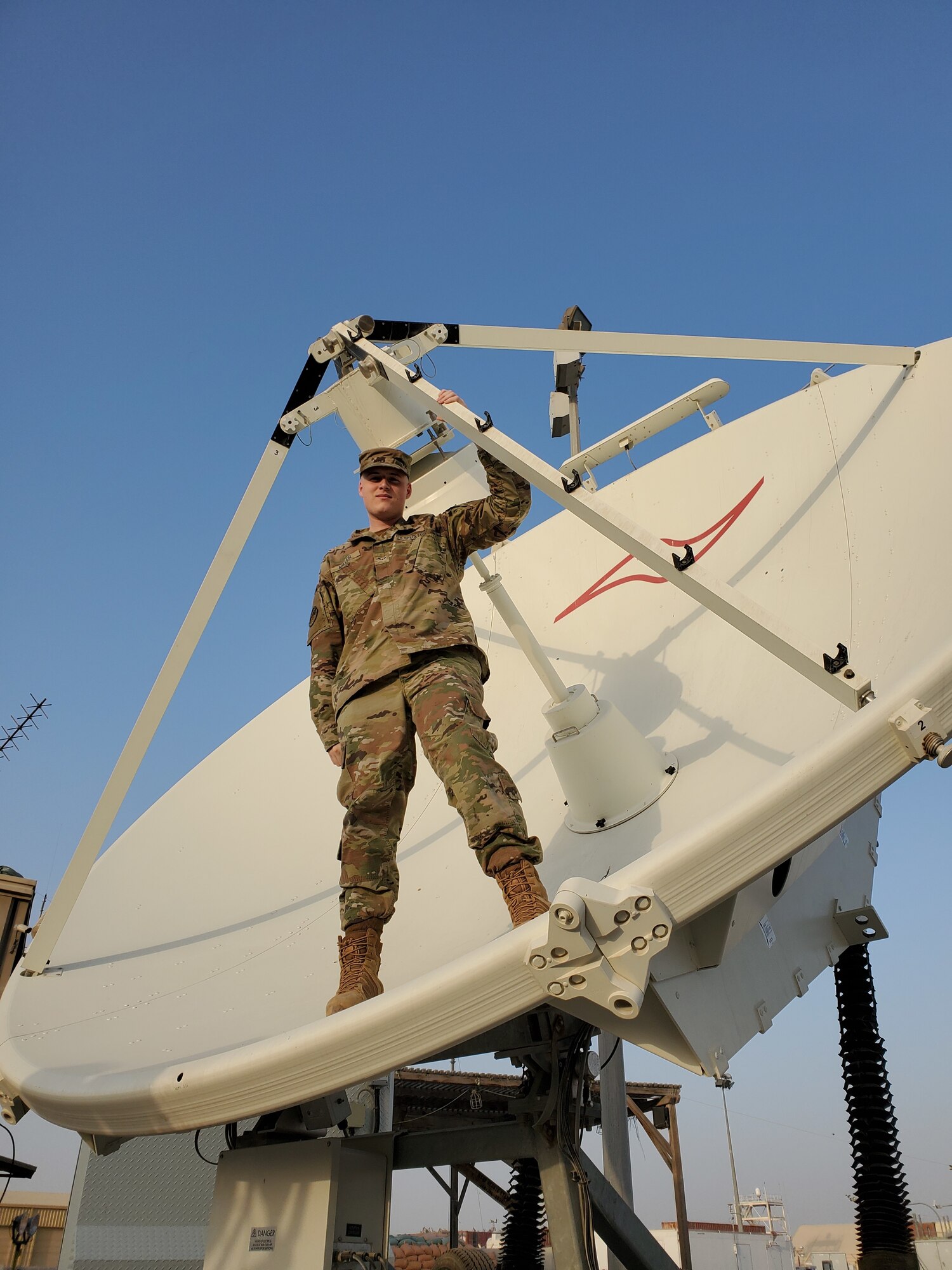 man standing in satellite dish