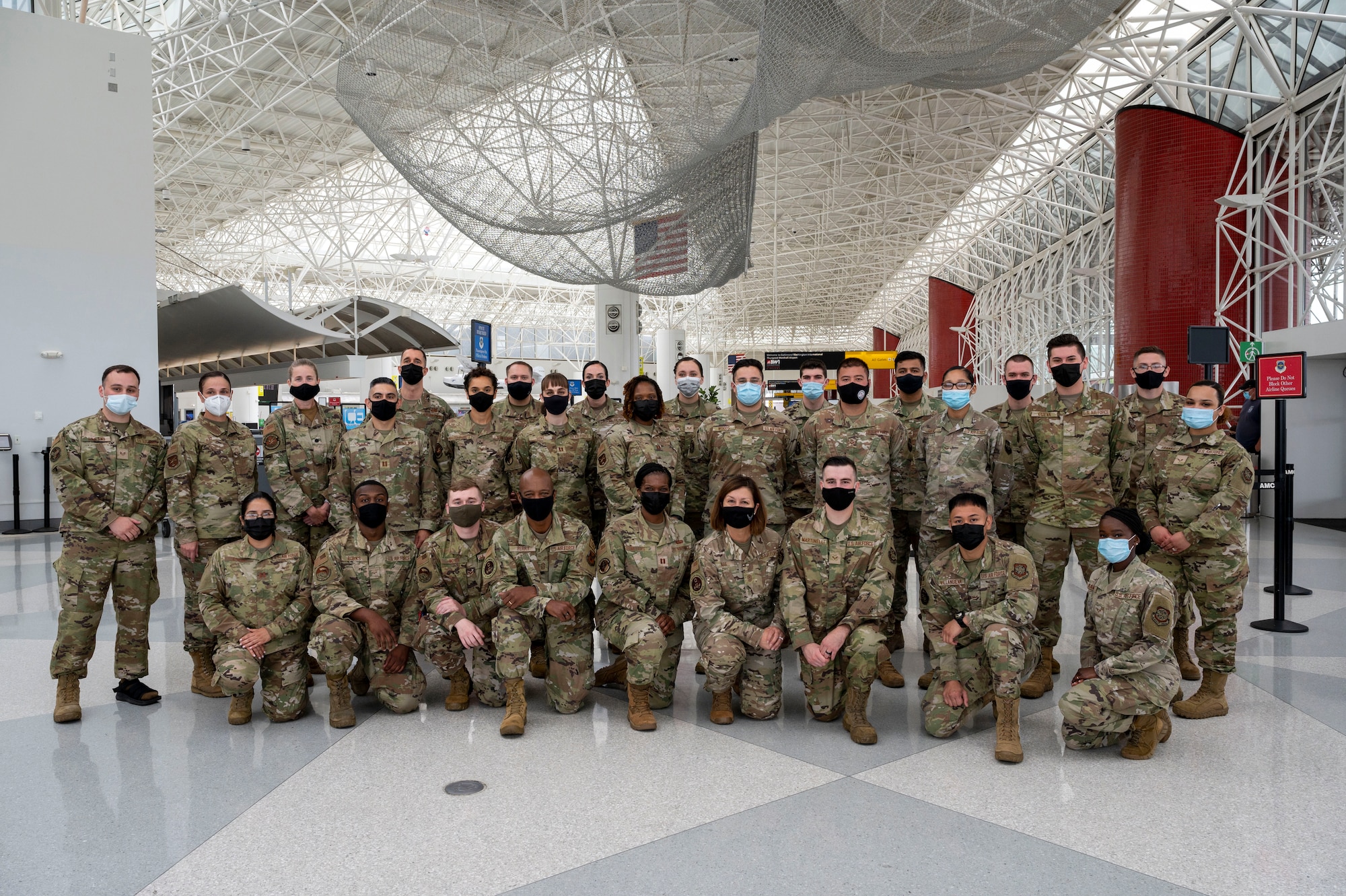 Chief Master Sgt. of the Air Force JoAnne S. Bass and Chief Master Sgt. Nathaniel Perry, Air Force First Sergeant Special Duty Manager, take a group photo with Airmen at the Patriot Express COVID-19 testing facility in the Baltimore/Washington International Thurgood Marshall Airport in Baltimore, July 8, 2021. The site provides on-site, rapid COVID-19 testing for service members and their families traveling to overseas duty locations. Due to the increased availability in COVID-19 testing centers and vaccines, testing at the BWI facility is scheduled to discontinue July 15, 2021. (U.S. Air Force photo by Airman 1st Class Cydney Lee)