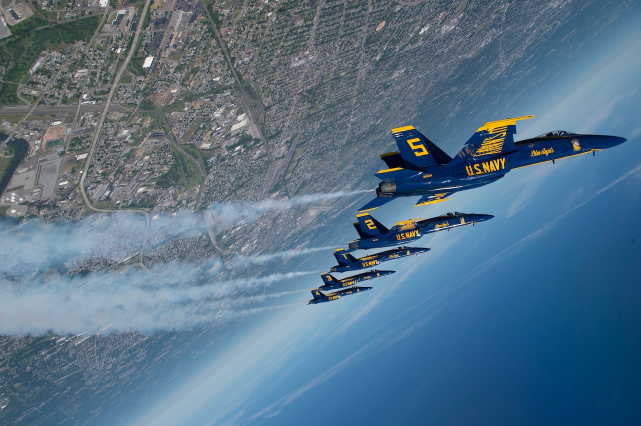 Aircraft fly in formation.