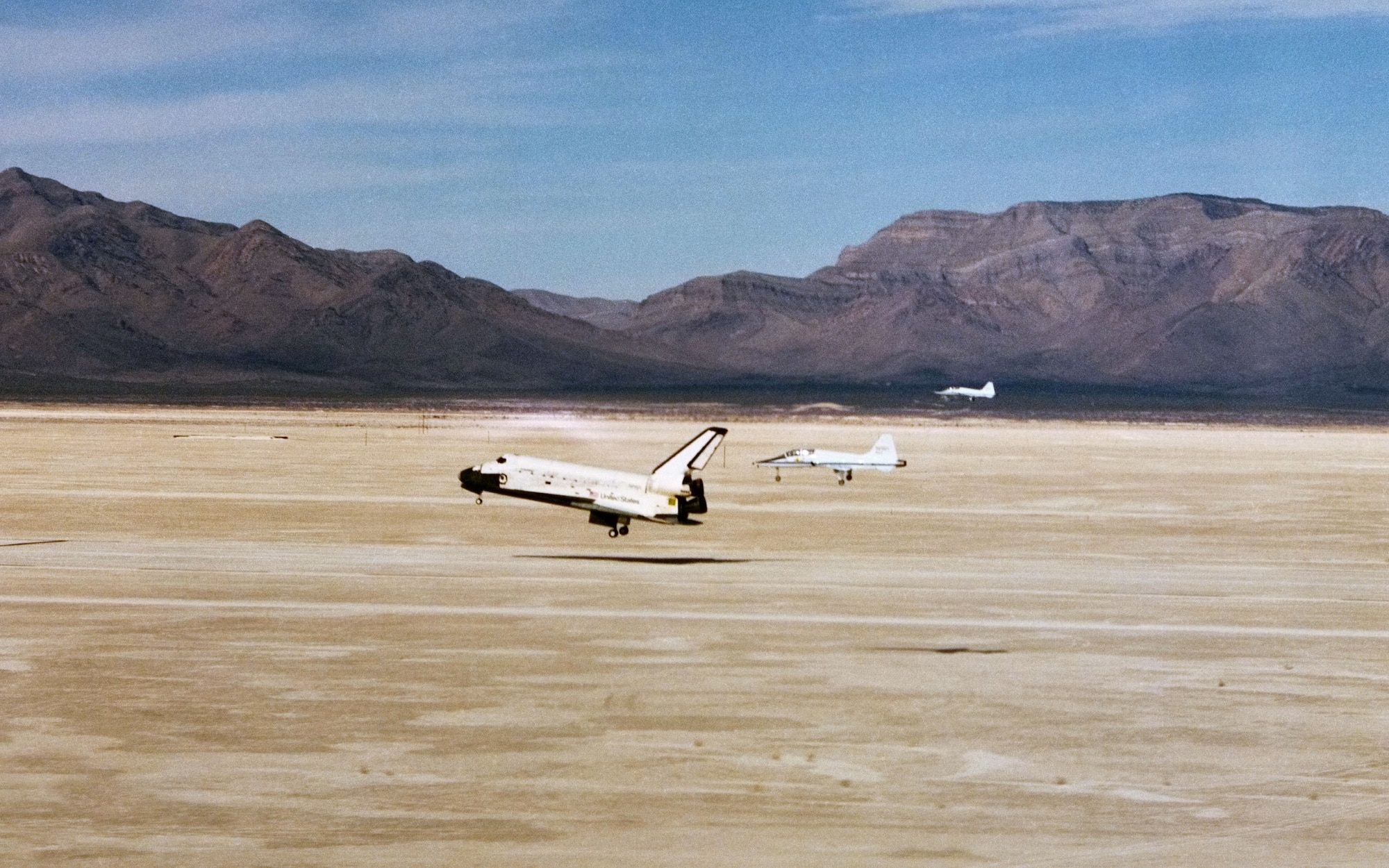 Two T-38 chase planes follow Space Shuttle Columbia as it lands at Northrop Strip in White Sands, New Mexico, ending its mission STS-3. (Photo NASA)
