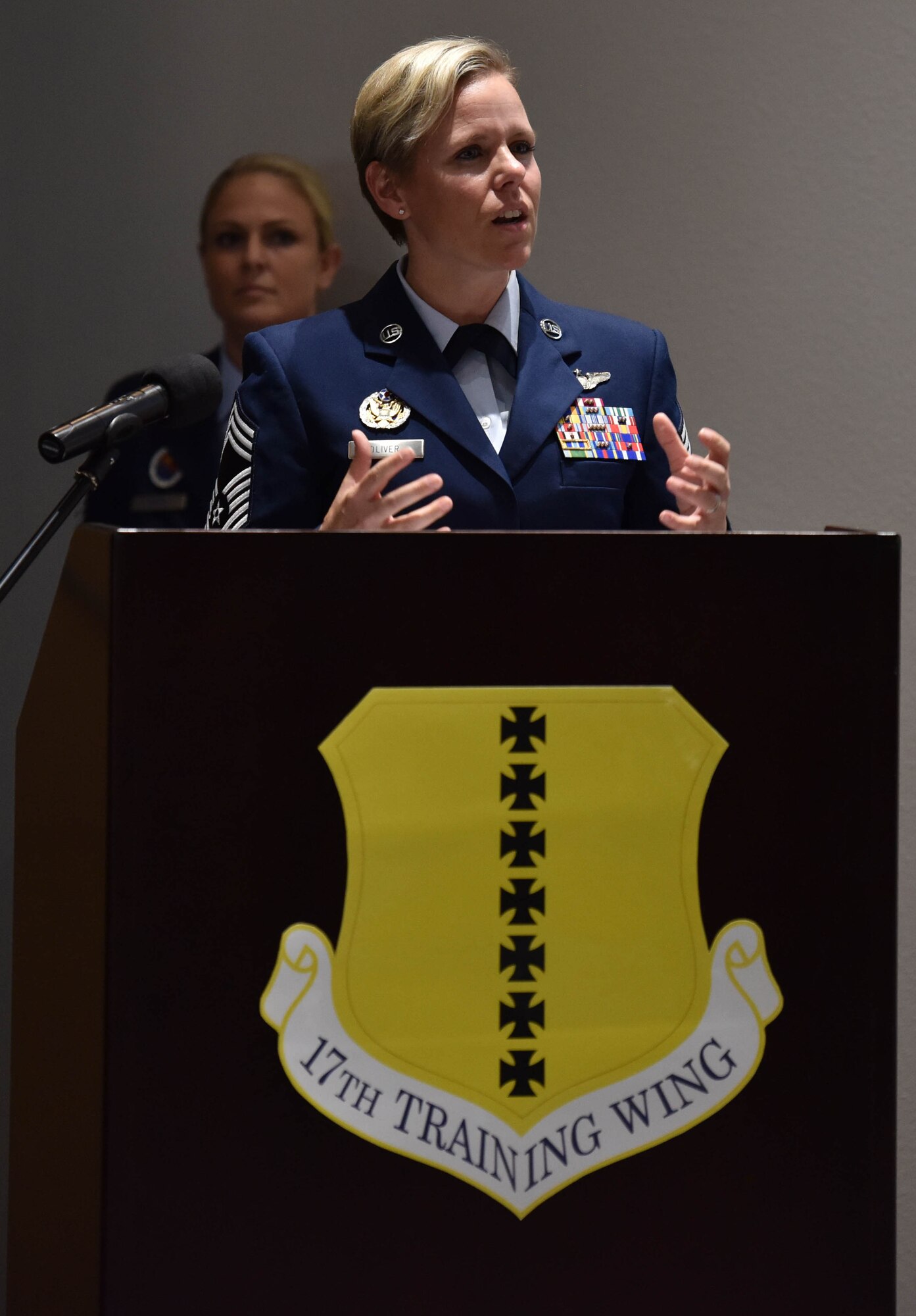 U.S. Air Force Chief Master Sgt. Breana Oliver, 17th Training Group superintendent, addresses Airman Leadership School, Class 21-E graduates, during the ALS graduation ceremony on Goodfellow Air Force Base, Texas, July 8, 2021. During the ceremony Oliver spoke about her experience with her very first supervisor and how she changed her life. (U.S. Air Force photo by Senior Airman Jermaine Ayers)