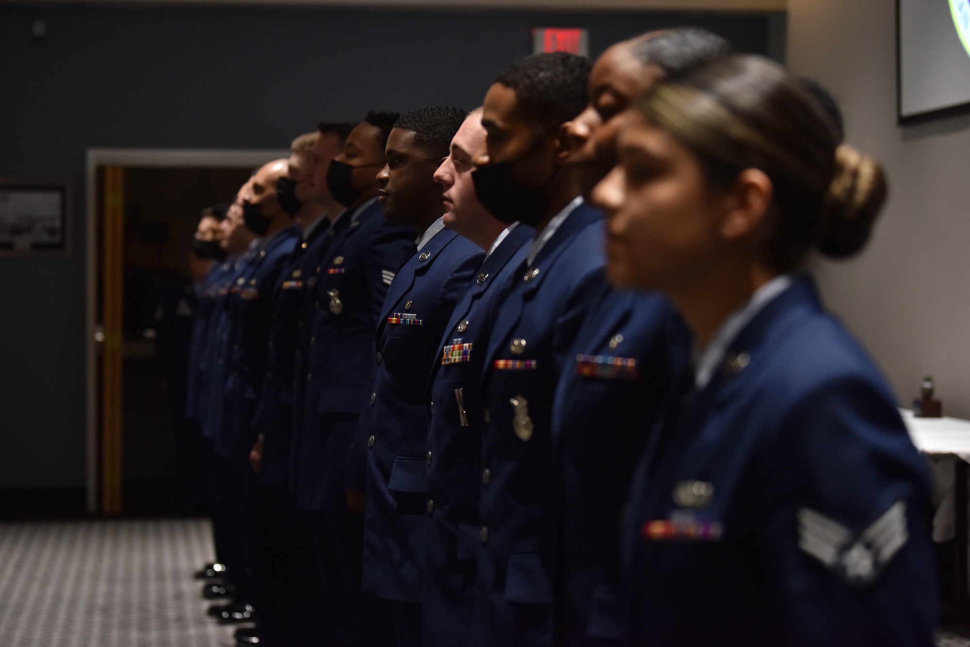 Airman Leadership School, Class 21-E graduates, line up to sing the Air Force song during the ALS graduation ceremony, on Goodfellow Air Force Base, Texas, July 8, 2021. ALS focuses on developing leadership abilities, the profession of arms, and building effective communication. (U.S. Air Force photo by Senior Airman Jermaine Ayers)