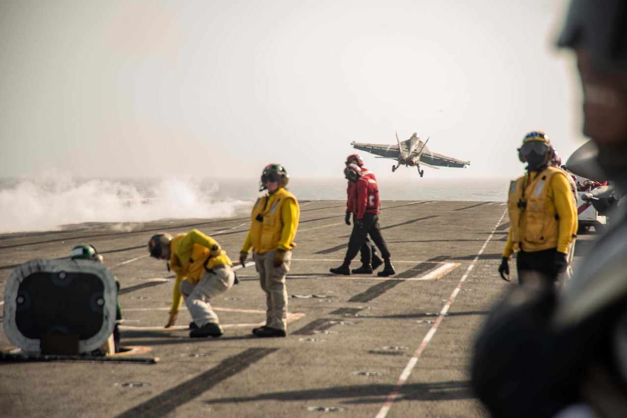 A jet takes off from a carrier.