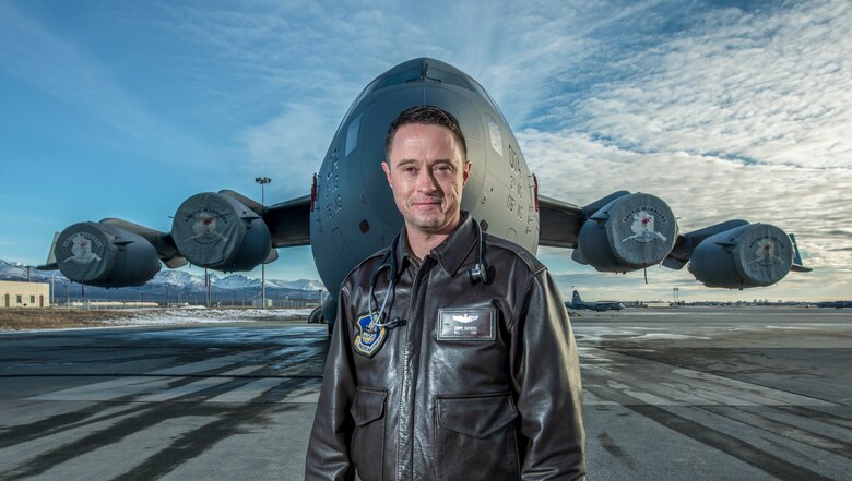 Maj. Chris Backus, a pilot-physician, stands in front of his airframe, a C-17 Globemaster III, on Joint Base Elmendorf-Richardson, Alaska, March 9, 2016. Pilot-physicians are involved in the research, development, testing, and evaluation of new and current Air Force systems and missions. Because of unique medical and human factors qualifications, pilot-physicians are particularly well suited to help develop new aircraft, life support equipment, and avionics or software upgrades. This is accomplished to enable aircrews to better adapt to the change in mission requirements. Backus is currently assigned to the 673rd Medical Group. (U.S. Air Force photo/Master Sgt. Brian Ferguson)