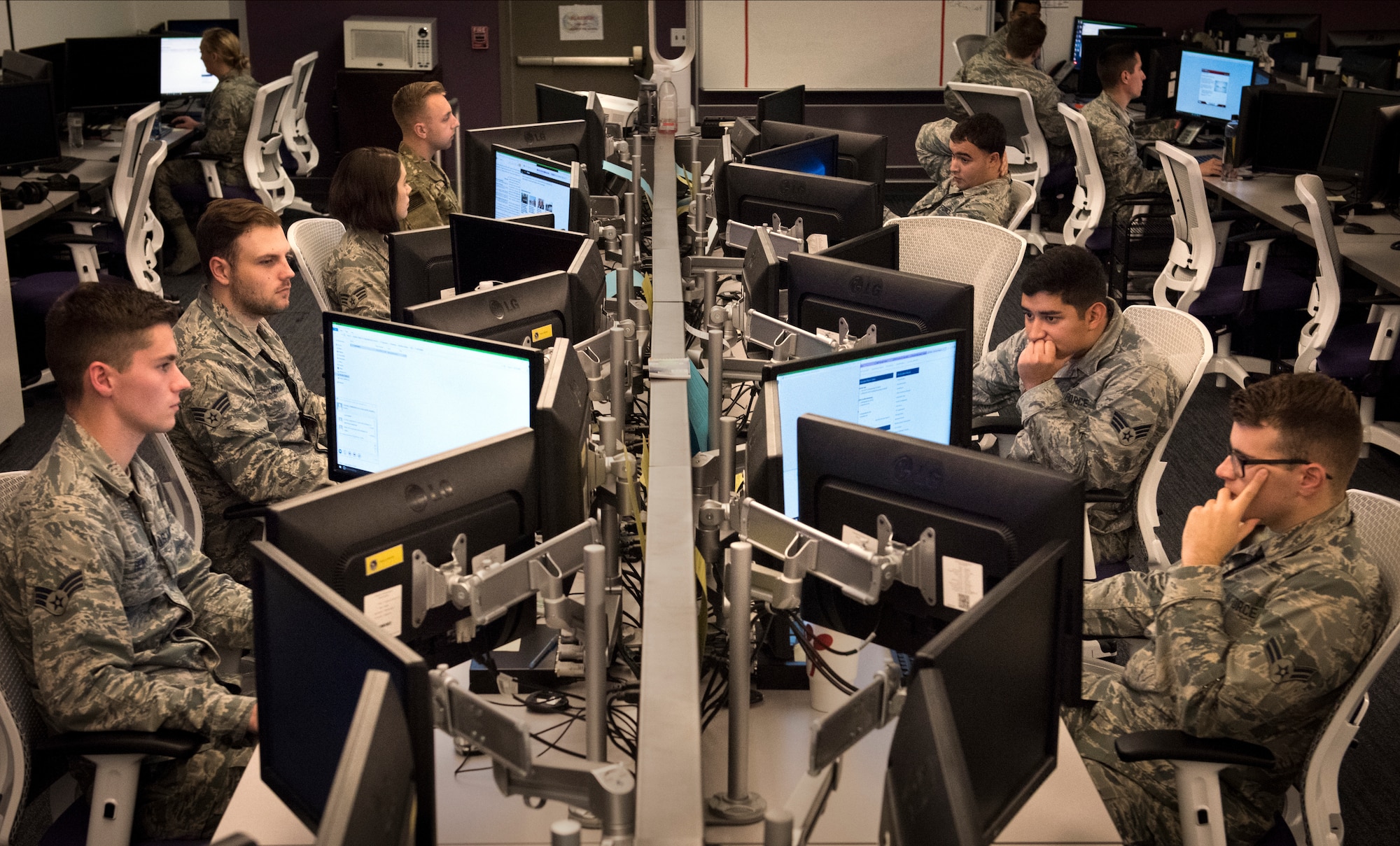 Airmen with the 68th Network Warfare Squadron monitor Air Force communications to analyze disclosures of critical information and perform data loss prevention at Joint Base San Antonio-Lackland, Texas, Oct. 25, 2018. (U.S. Air Force photo by J.M. Eddins Jr.)