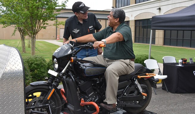 Rafael Santos, chief of the U.S. Army Space and Missile Defense Command’s Military Personnel Division, learns about motorcycle safety from Paul Walker, Redstone Harley Davidson, at the USASMDC Safety and SHARP Awareness Day at the command’s Redstone Arsenal, Alabama, headquarters June 29, 2021. (U.S. Army photo by Jason Cutshaw)