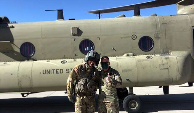 1st Lt. Bradley Cho, a platoon leader at Company B, 2-501 General Support Aviation Battalion, left, and his father-in-law, Lt. Gen. Daniel Karbler, commanding general, U.S. Army Space and Missile Defense Command, pose for a photo just before Cho flies Karbler from Fort Bliss, Texas, to White Sands Missile Range, New Mexico, April 7. (U.S. Army photo)