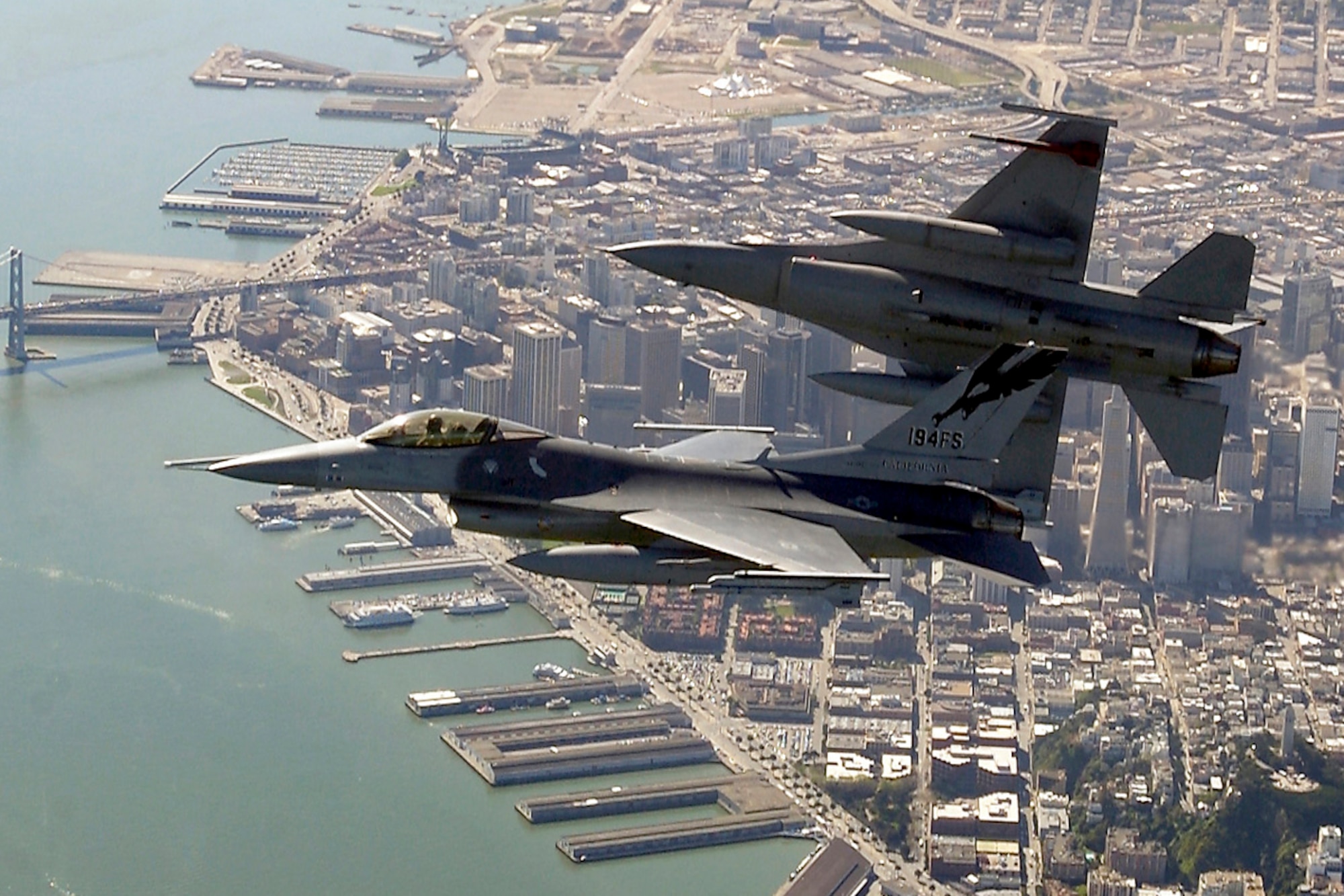 Two F-16 Fighting Falcons begin to roll into position for a rapid decent during an Operation Noble Eagle training patrol over San Francisco, Calif. The F-16s are assigned to the California Air National Guard's 144th Fighter Wing in Fresno, Calif.  (U.S. Air Force photo by Master Sgt. Lance Cheung)