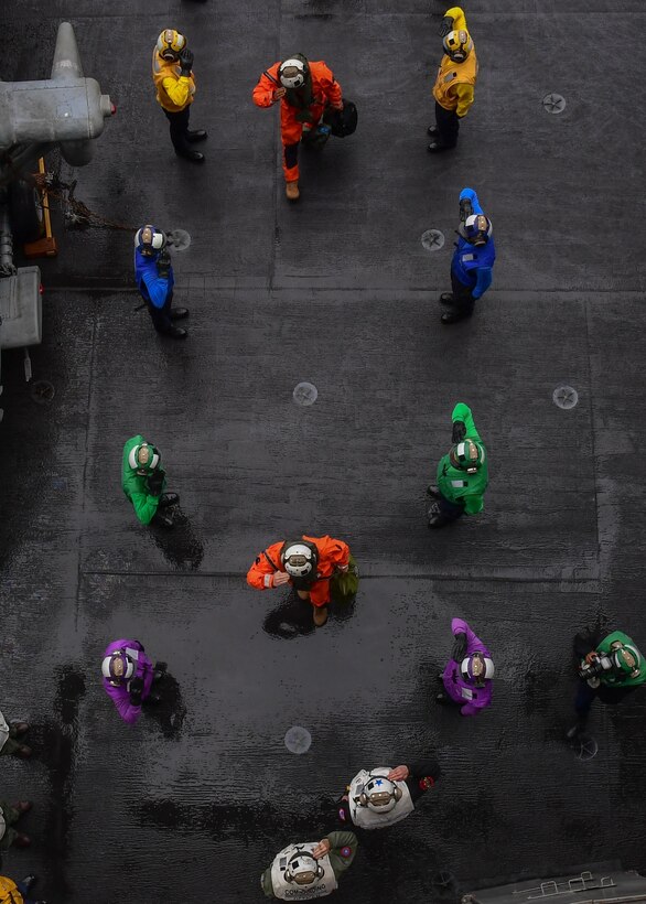 U.S. Air Force Gen. Ken Wilsbach, commander, Pacific Air Forces, shown here in the orange flight suit near the bottom, passes through ceremonial side-boys aboard the aircraft carrier USS Theodore Roosevelt (CVN 71), May 10, 2021, in the Gulf of Alaska during Exercise Northern Edge 2021 (NE21). NE21 is one in a series of U.S. Indo-Pacific Command exercises designed to sharpen the joint forces' skills; to practice tactics, techniques, and procedures; to improve command, control, and communication relationships; and to develop cooperative plans and programs. Approximately 15,000 U.S. service members are participating in a joint training exercise hosted by U.S. Pacific Air Forces May 3-14, 2021, on and above the Joint Pacific Alaska Range Complex, the Gulf of Alaska, and temporary maritime activities area. (U.S. Navy photo by Mass Communication Specialist Seaman Apprentice Juan J. Ruiz-Lazcano)