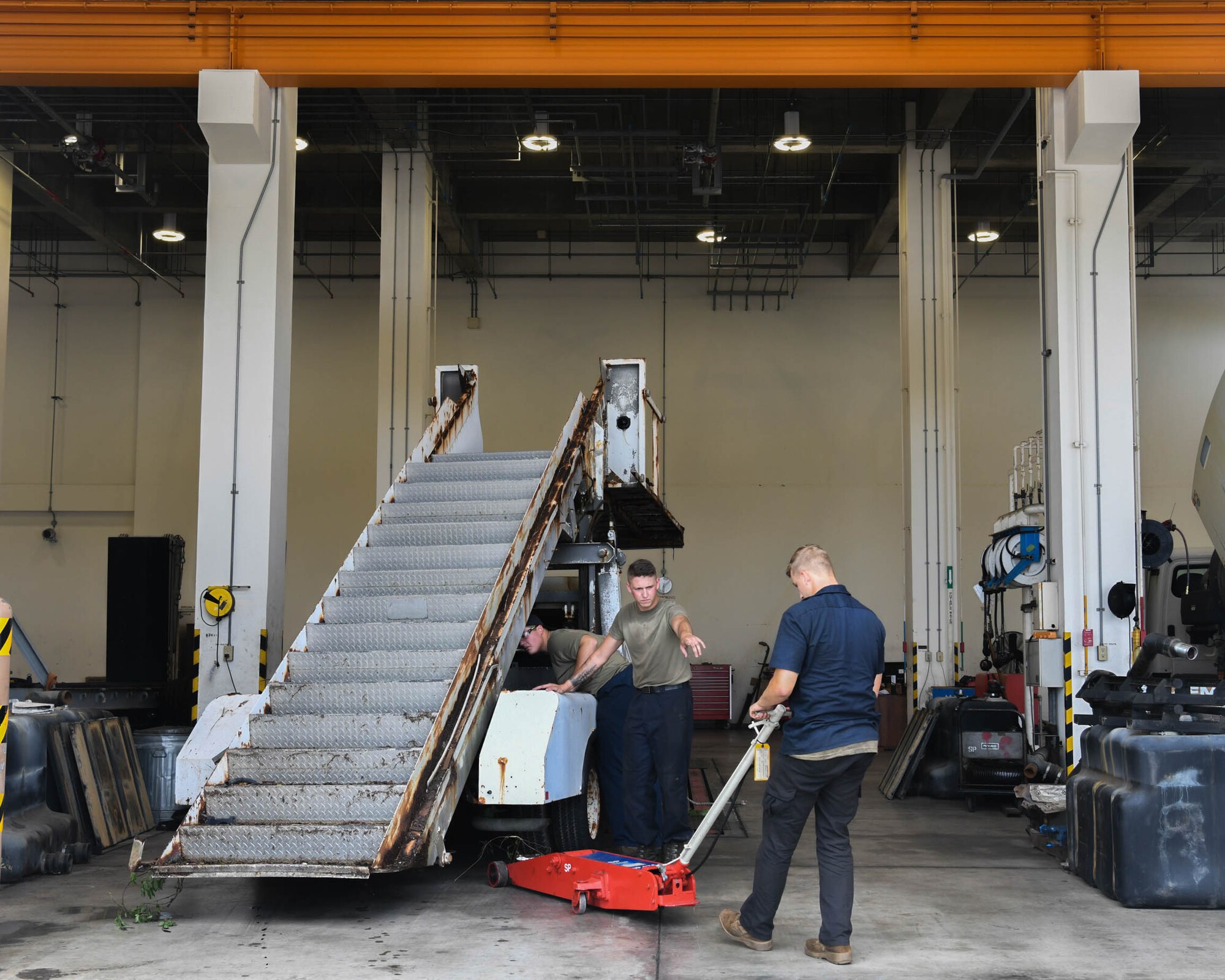 Special Purpose technicians work on disassembling a staircase truck at Kadena Air Base, Japan, June 16, 2021.