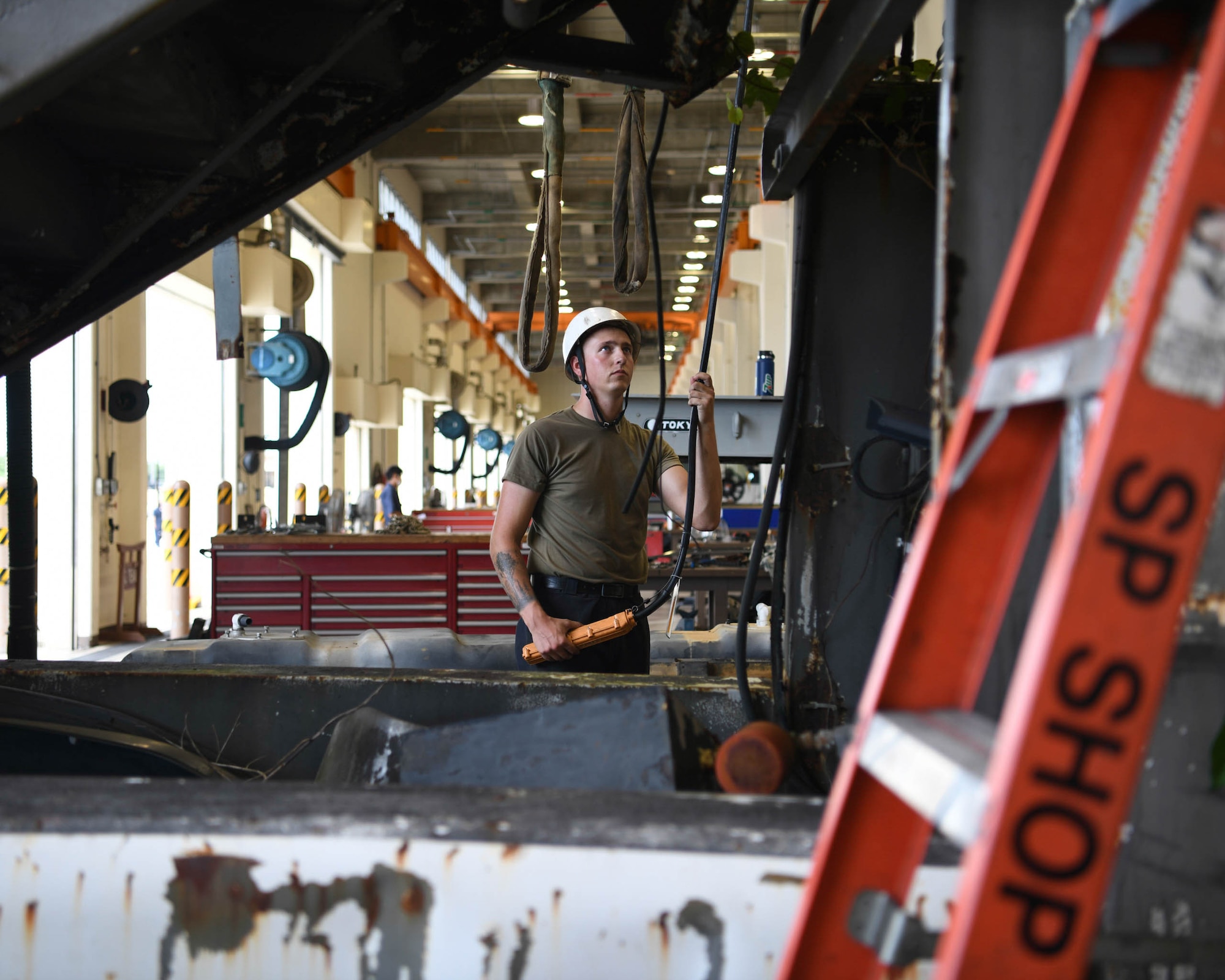 Special Purpose technicians work on disassembling a staircase truck at Kadena Air Base, Japan, June 16, 2021.