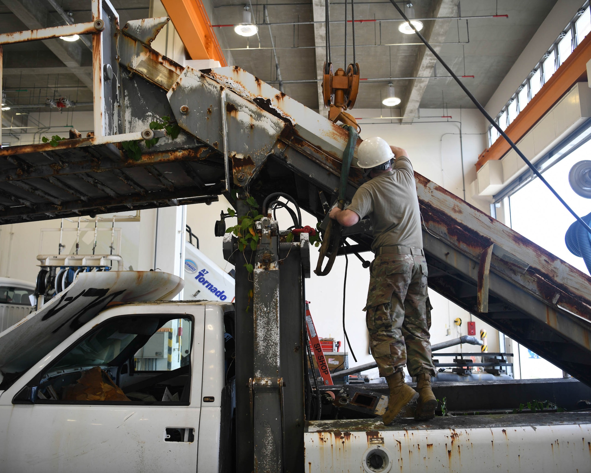 Special Purpose technicians work on disassembling a staircase truck at Kadena Air Base, Japan, June 16, 2021.