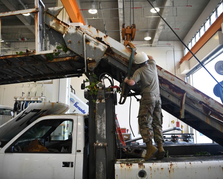 Special Purpose technicians work on disassembling a staircase truck at Kadena Air Base, Japan, June 16, 2021.