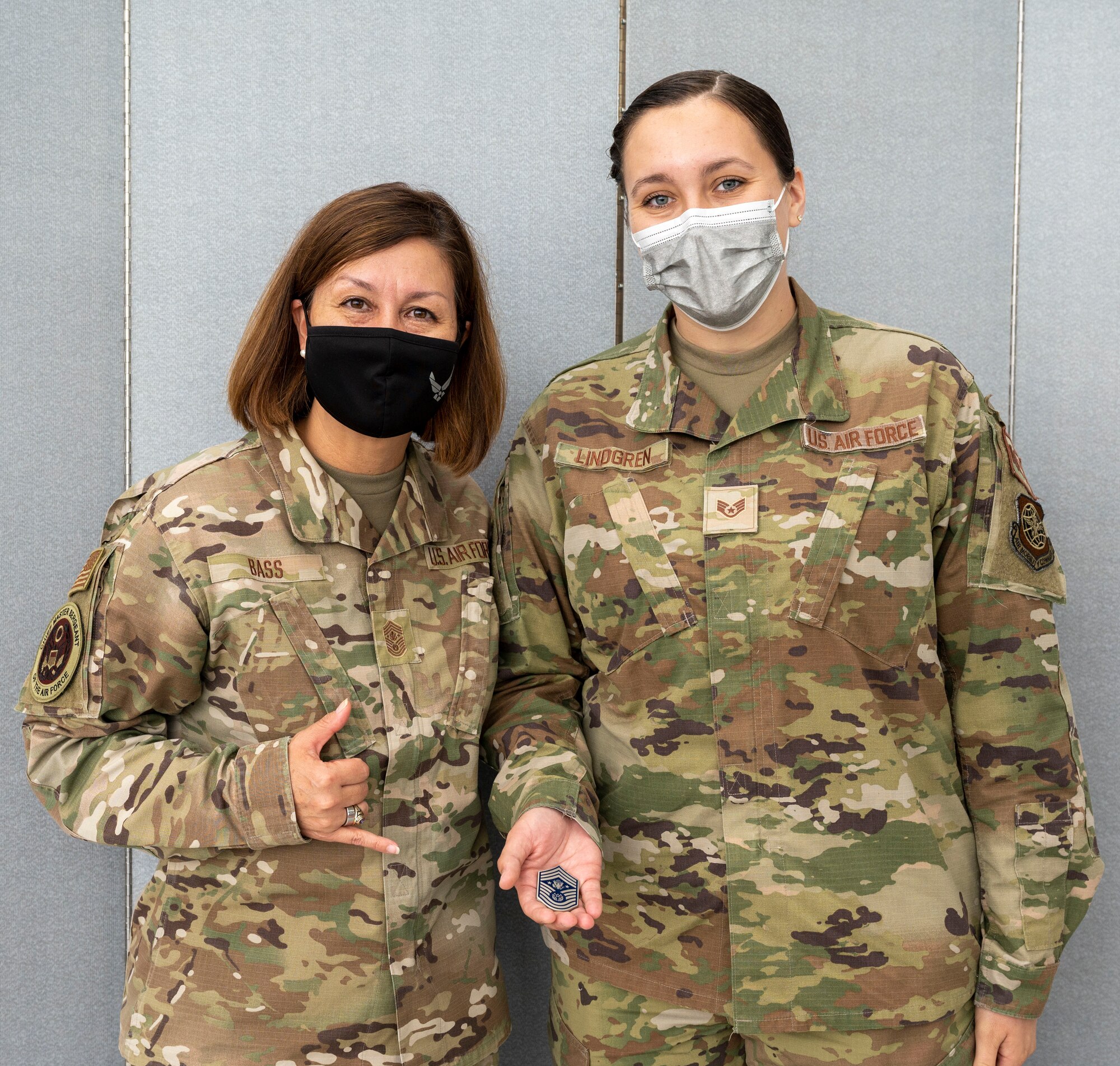 Chief Master Sgt. of the Air Force JoAnne S. Bass coins Staff Sgt. Karley Lindgren, 87th Operational Medical Readiness Squadron flight and operations medical technician, at the Patriot Express COVID-19 testing facility in the Baltimore/Washington International Thurgood Marshall Airport in Baltimore, July 8, 2021. The site provides on-site, rapid COVID-19 testing for service members and their families traveling to overseas duty locations. Due to the increased availability in COVID-19 testing centers and vaccines, testing at the BWI facility is scheduled to discontinue July 15, 2021. (U.S. Air Force photo by Airman 1st Class Cydney Lee)