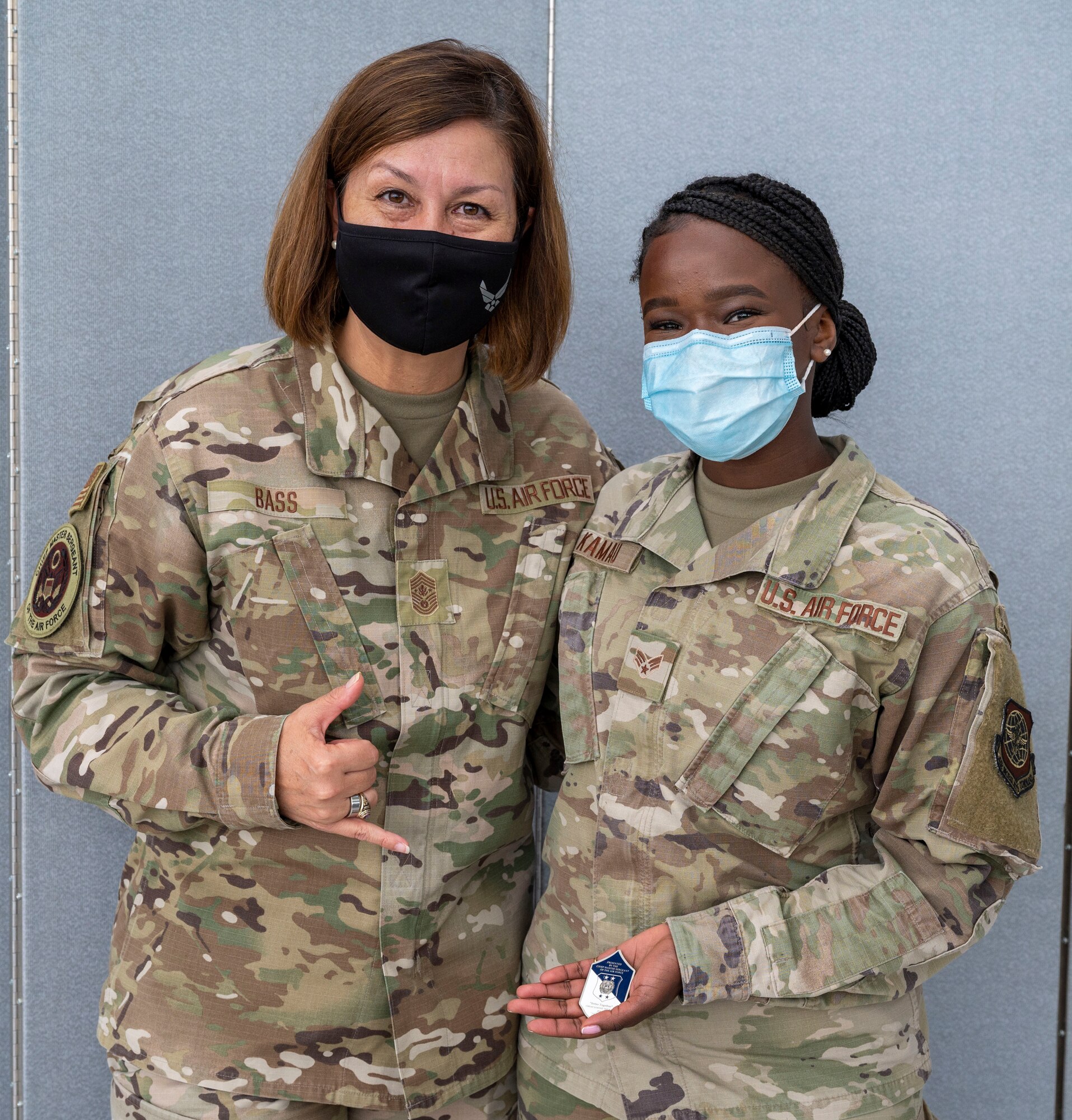 Chief Master Sgt. of the Air Force JoAnne S. Bass coins Senior Airman Annette Kamau, 87th Health Care Operations Squadron medical technician, at the Patriot Express COVID-19 testing facility in the Baltimore/Washington International Thurgood Marshall Airport in Baltimore, July 8, 2021. Since November 2020, the operation ensured U.S. Transportation Command’s fulfillment of national security requirements while providing for the health and safety of service members and their families. Due to the increased availability in COVID-19 testing centers and vaccines, testing at the BWI facility is scheduled to discontinue July 15, 2021. (U.S. Air Force photo by Airman 1st Class Cydney Lee)