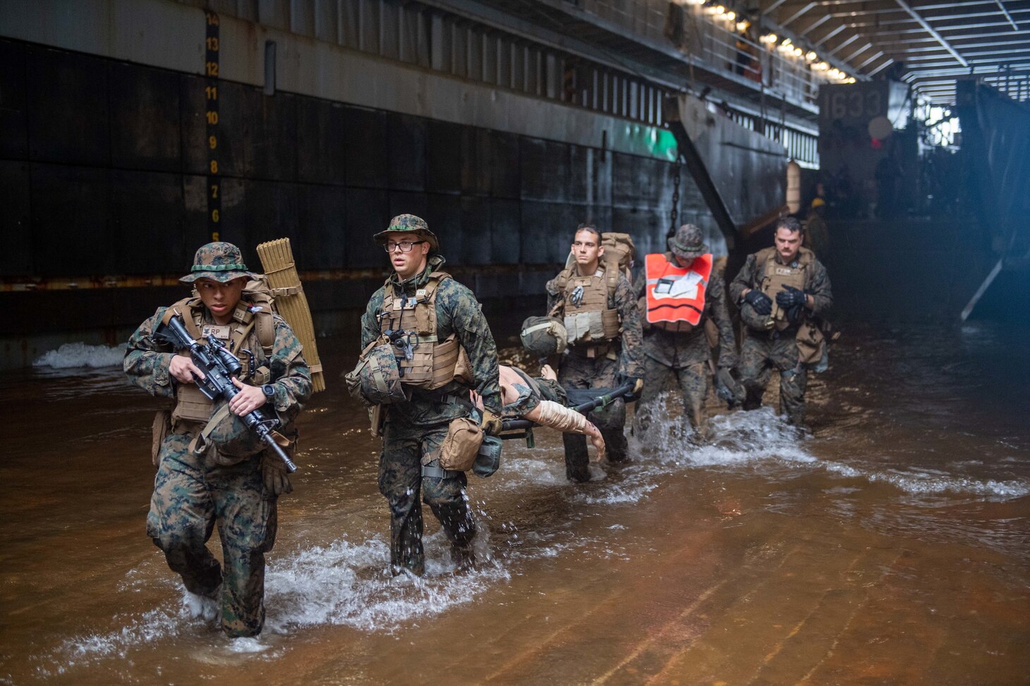 210630-N-IJ902-1139 Philippine Sea (June 30, 2021)—Marines from the 31st Marine Expeditionary Unit (31st MEU) participate in a mass casualty drill while disembarking from Landing Craft Unit 1633 (LCU 1633) into the well deck of the amphibious dock landing ship, USS Germantown (LSD-42). Germantown, part of Amphibious Squadron 11, along with the 31st Marine Expeditionary Unit, is operating in the U.S. 7th Fleet area of responsibility to enhance interoperability with allies and partners and serve as a ready response force to defend peace and stability in the Indo-Pacific region. (U.S. Navy photo by Mass Communication Specialist Seaman Apprentice Nicholas M. Skyles)