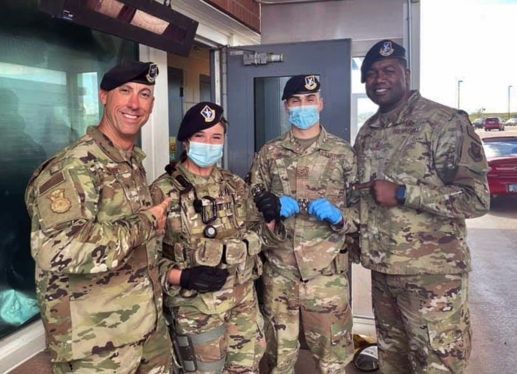 Airman Suzanne Pedro and Airman 1st Class Frank Shaw, both from the 90th Security Forces Squadron, pose with Col. Damian Schlussel (left), 90th Security Forces Group commander, and Chief Master Sgt. Charles Flanagain (right), 90 SFG chief enlisted manager, for a photo on F.E. Warren Air Force Base, Wyoming, July 7, 2021. The Airmen were coined by their leadership in recognition of excellence while performing their duties. Their actions in defending the base directly contributed to the capture of an individual with active arrest warrants and the recovery of a missing child. (Courtesy photo)