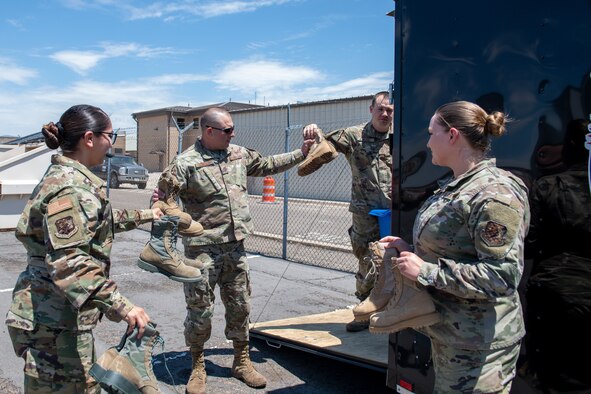 Airmen from the 419th and 388th Fighter Wings load a trailer with boots for a boot drive at Hill Air Force Base, Utah, on July 7, 2021.